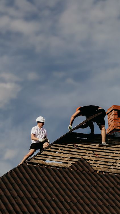 Roofing crew making targeted roof repairs