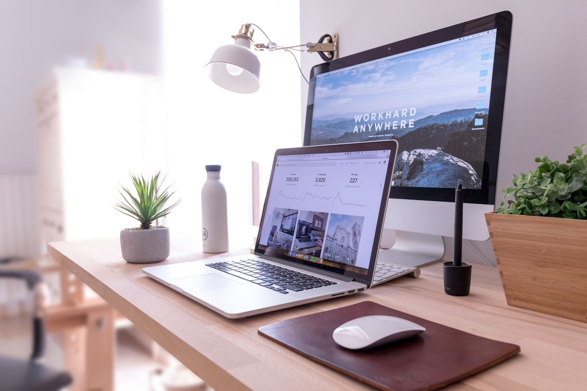 A designer working on a laptop in soft natural light — the kind of workspace where ideas become crafted digital experiences.