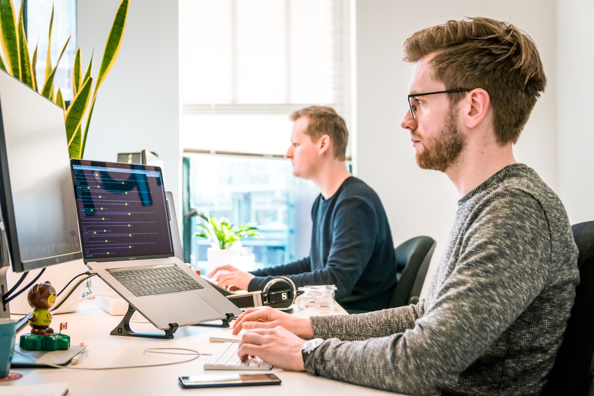 A small, focused team collaborating around a clean workspace — the kind of studio that ships carefully.