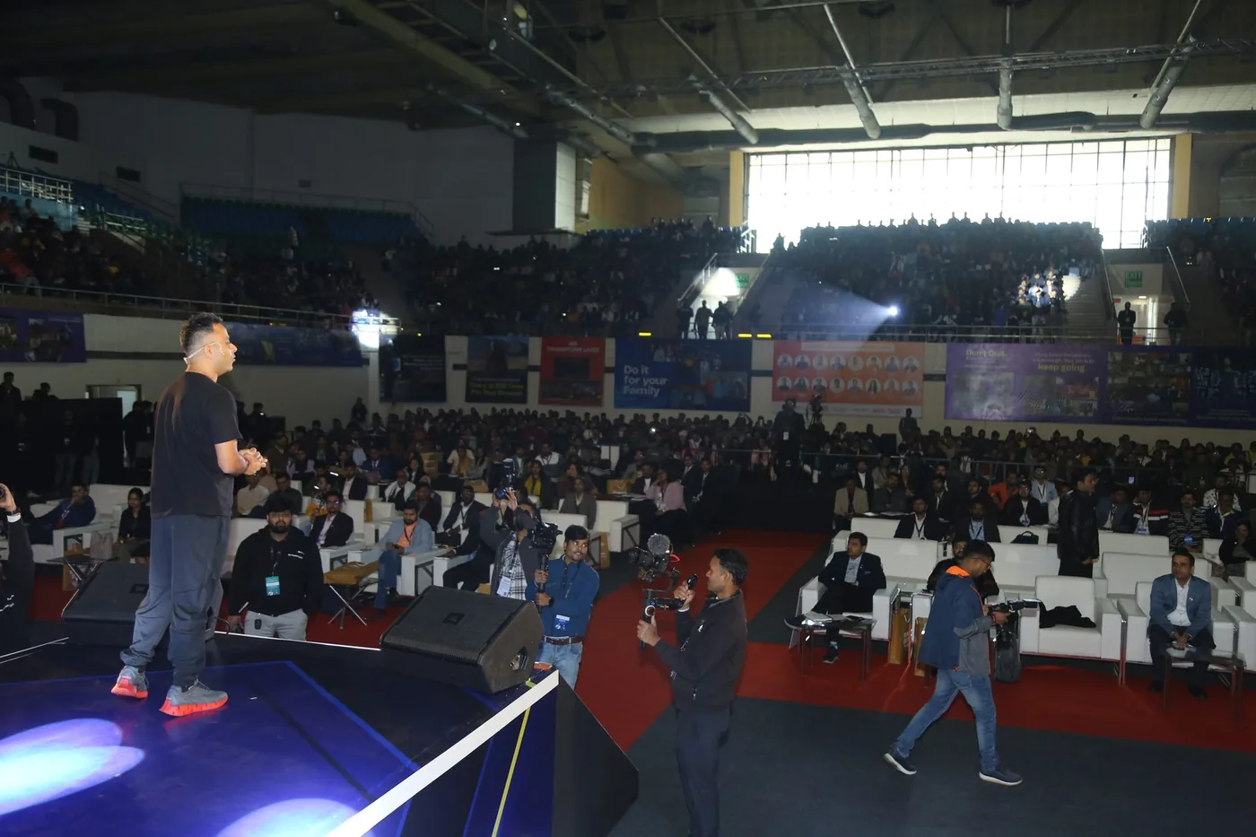Saurabh Bhatnagar on stage looking out at a packed arena at his own event